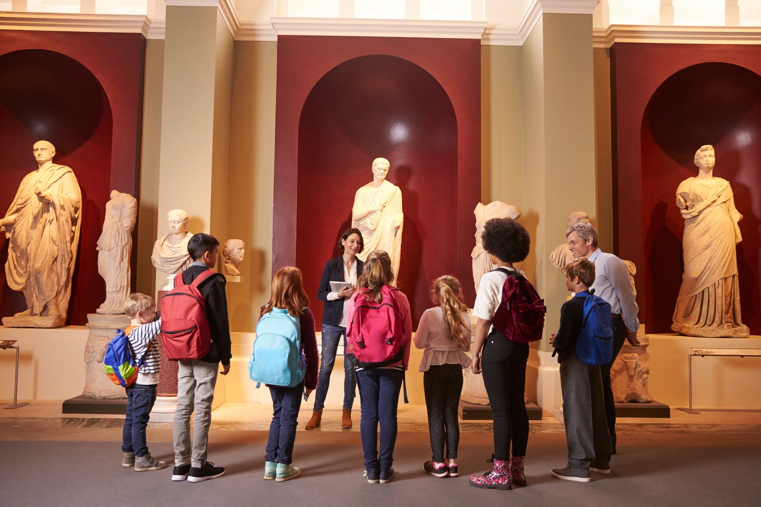 Pupils and Teacher on School Field Trip to Museum with Guide